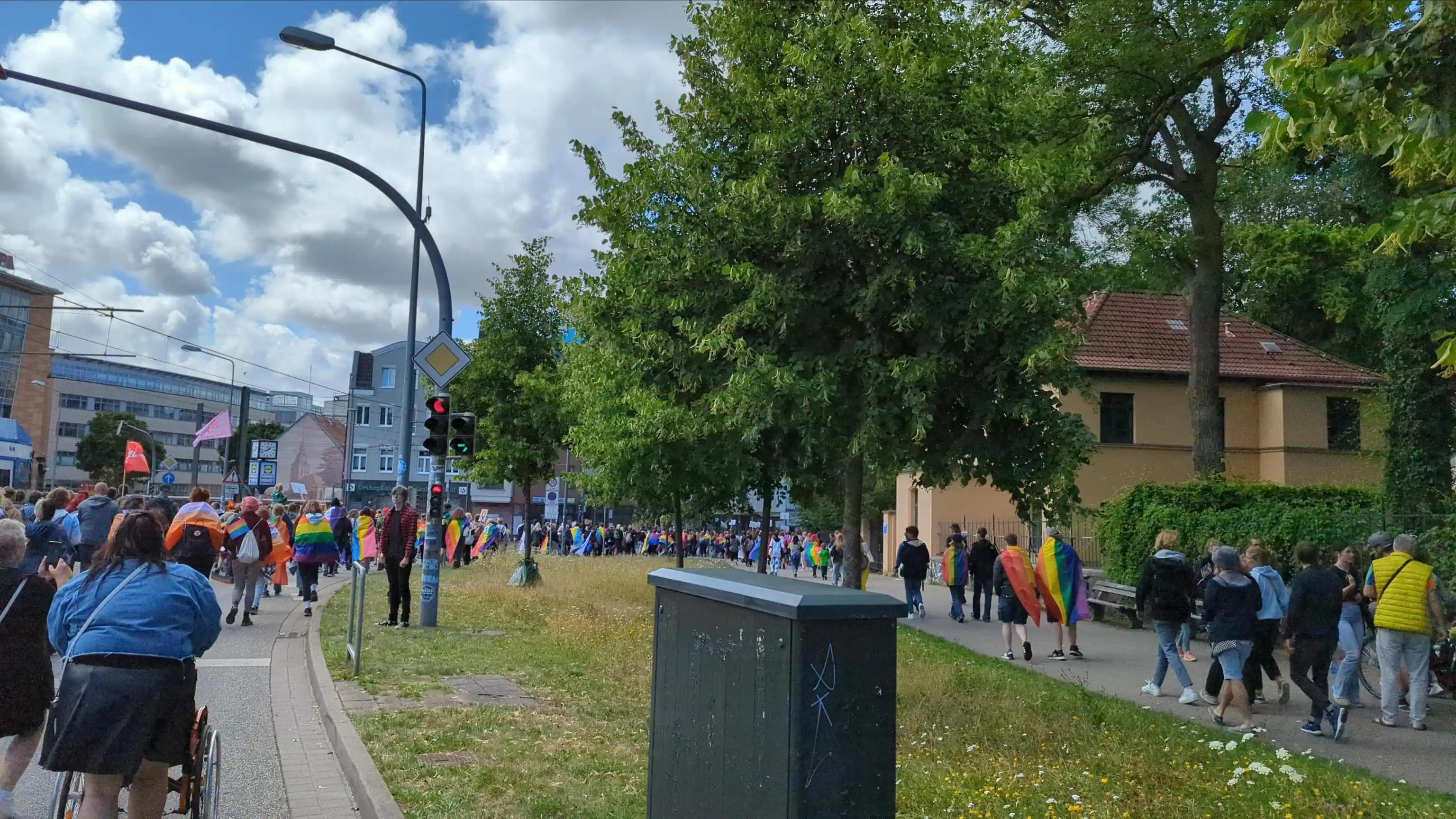 Rainbow people walking along a curve