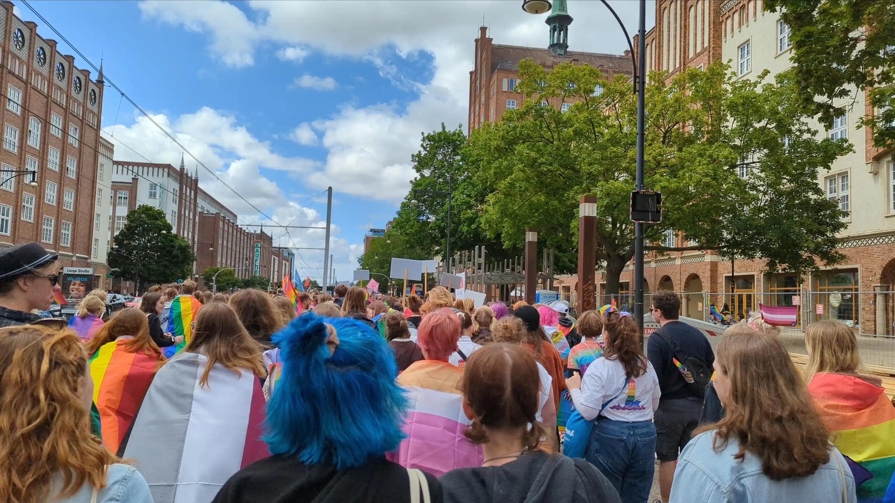 Lots of rainbow people (i.e. people wearing and carrying various colourful pride flags and the like)